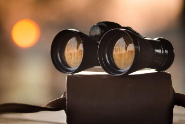 organic search for drug rehabs, binoculars sitting on desk representing search in a busy world