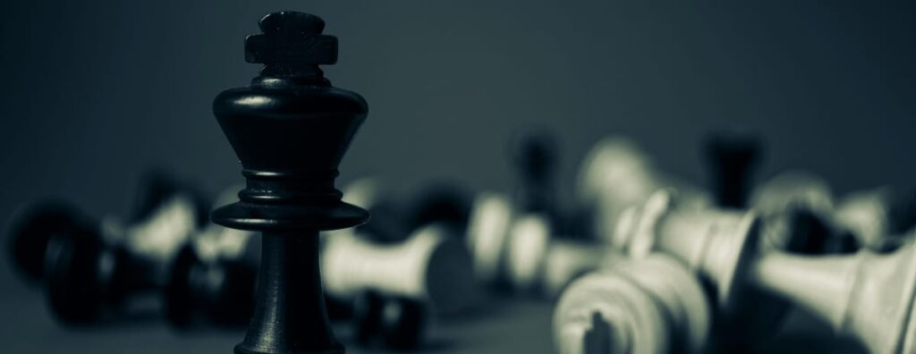 A dominant chess piece standing tall while all others are toppled, symbolizing the effectiveness of strategic rehab SEO.