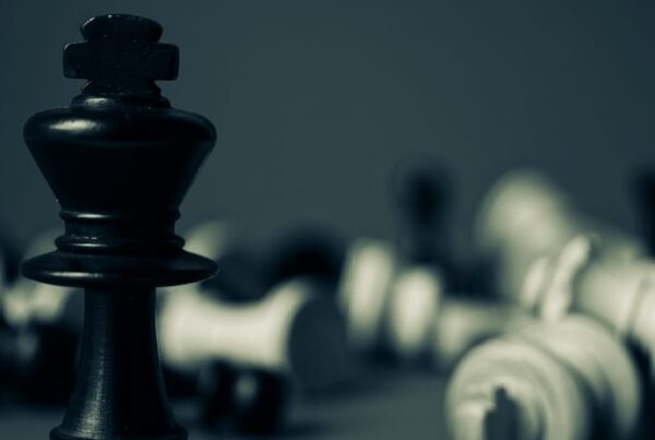 A dominant chess piece standing tall while all others are toppled, symbolizing the effectiveness of strategic rehab SEO.